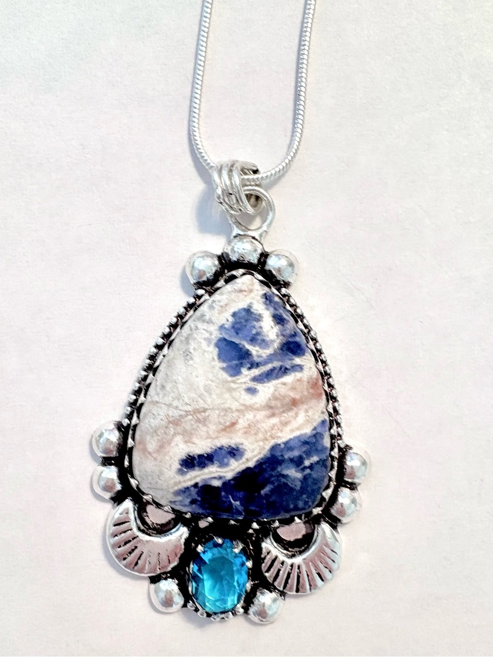 2 inch. 925 marked, Sodalite and Blue Topaz pendant on a silver chain.